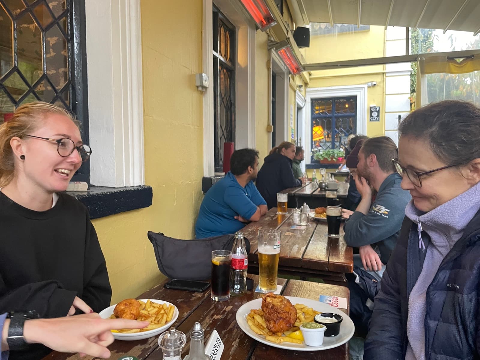 People talking over food at a pub after the Howth Cliff Walk.